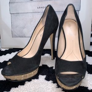 Black pumps with gold chain embellishments